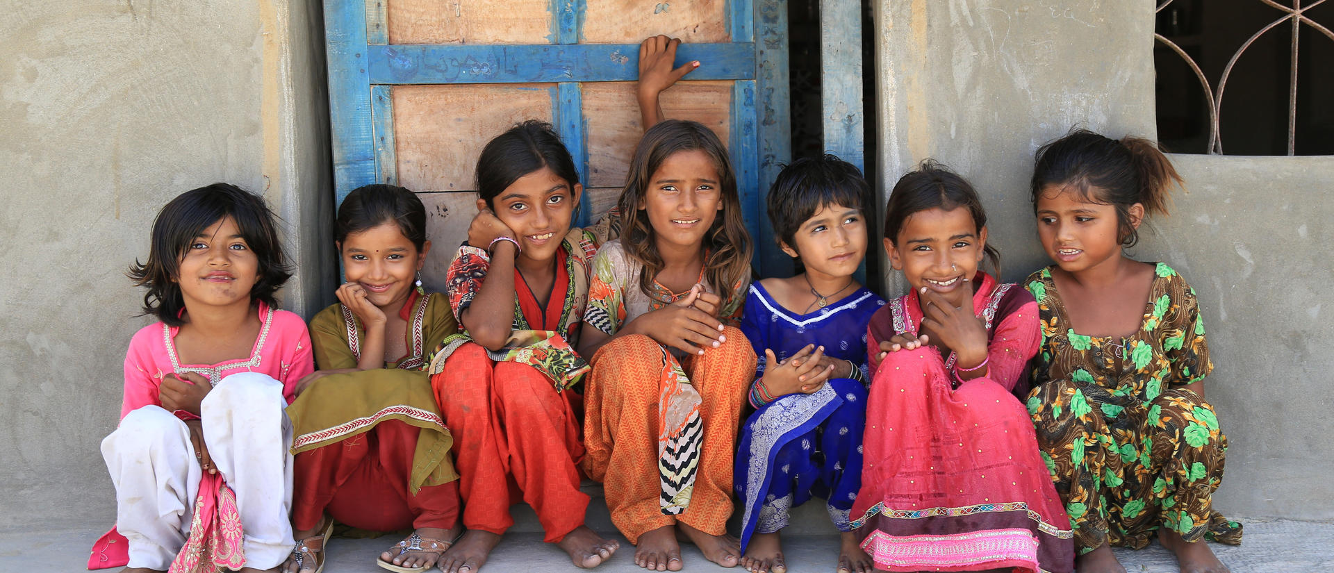 Children sitting against wall image